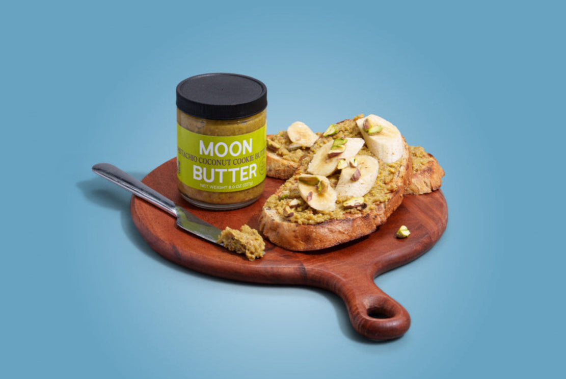 Pistachio Coconut Cookie Butter Moon Butter jar on toast with banana and pistachio