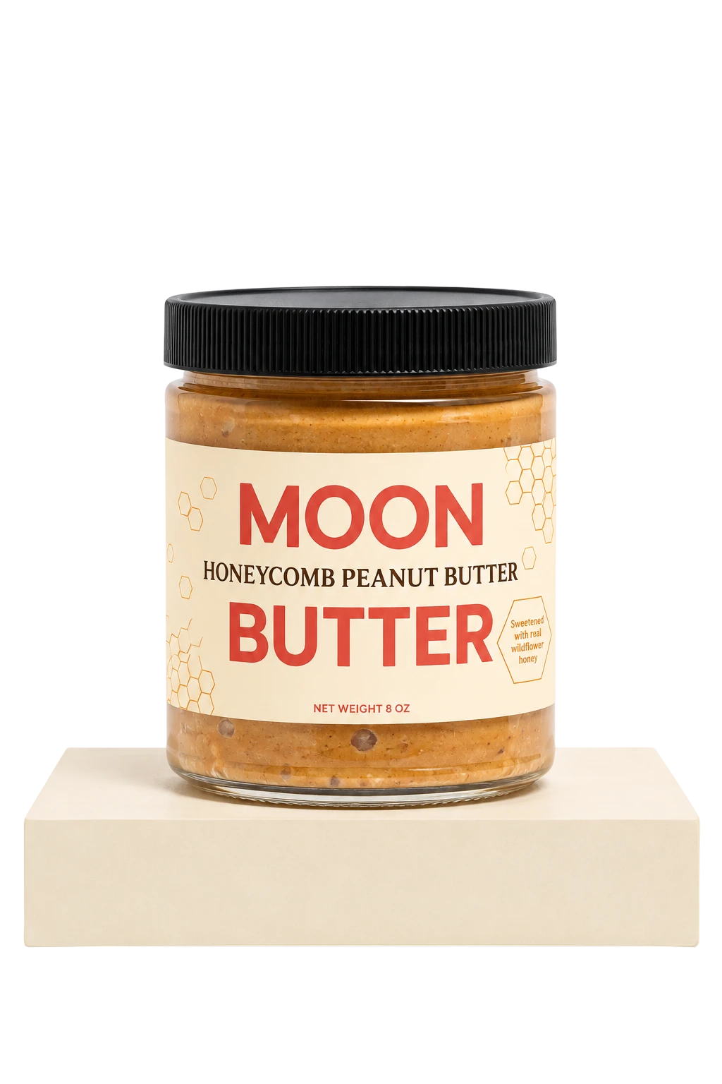 A jar of Honeycomb Peanut Butter on a cream pedestal