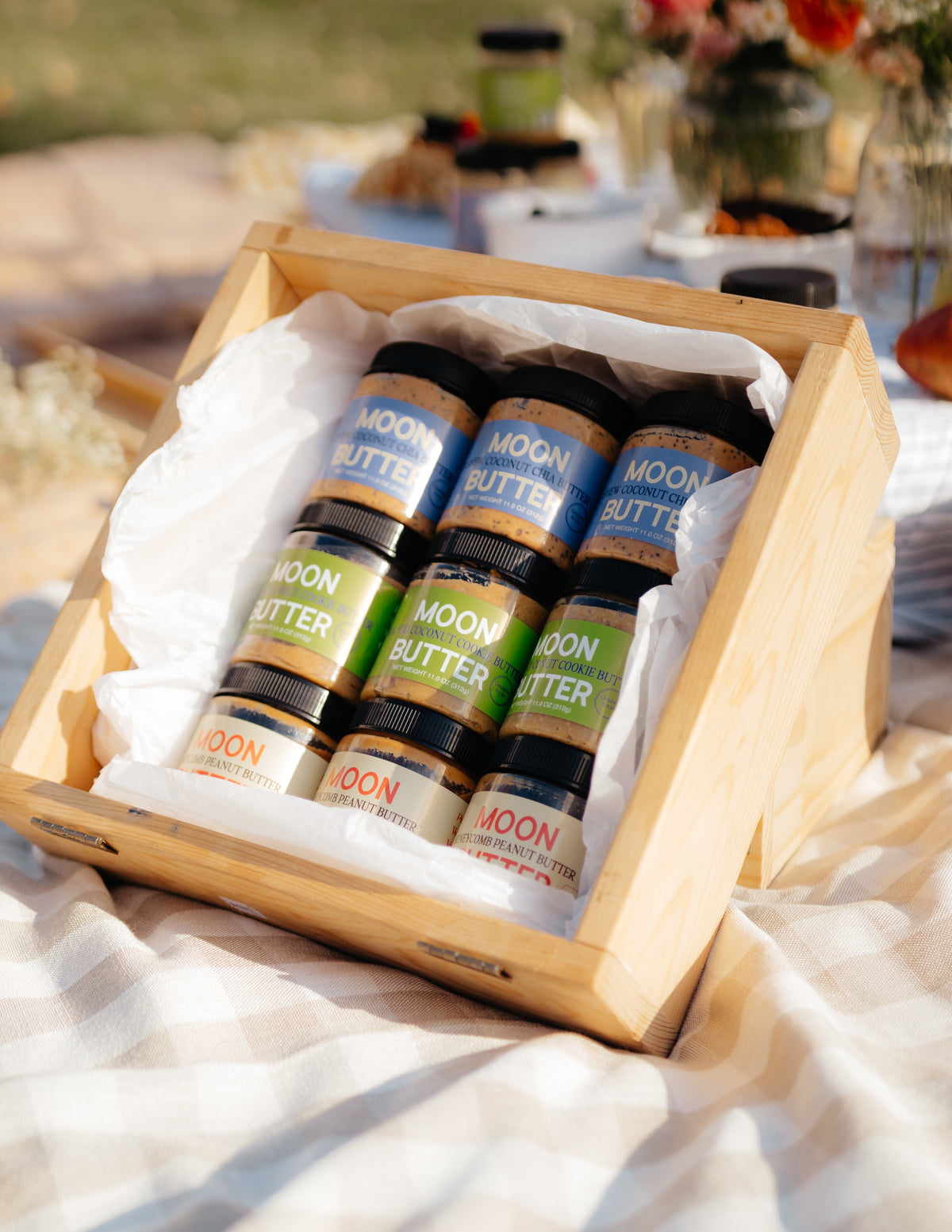 A wooden gift box filled with three flavors of Moon Butter